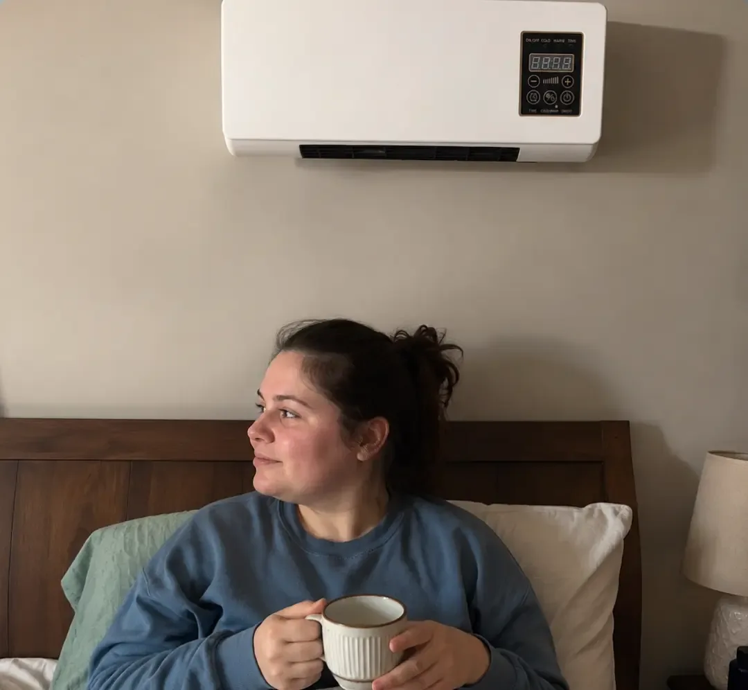 White wall mounted heater above a bed